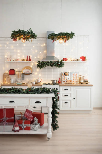 white kitchen interior with classic christmas decor and lights. - home decoration stock pictures, royalty-free photos & images