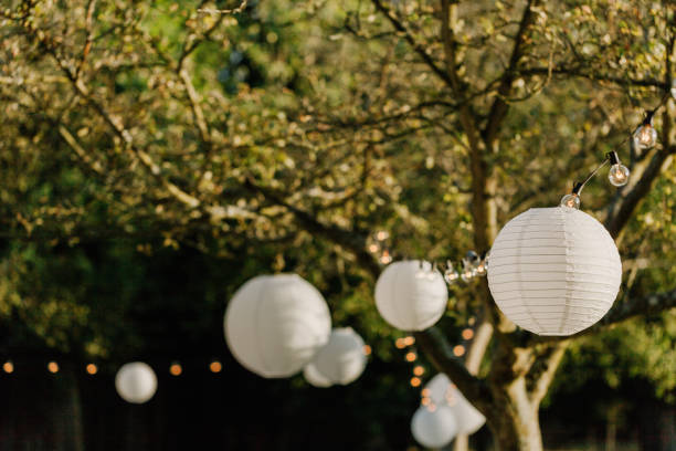white lanters on a wedding in a garden - garden decoration stock pictures, royalty-free photos & images