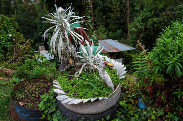 white swan-shaped pot plant holder made from a used car tire - garden decoration stock pictures, royalty-free photos & images