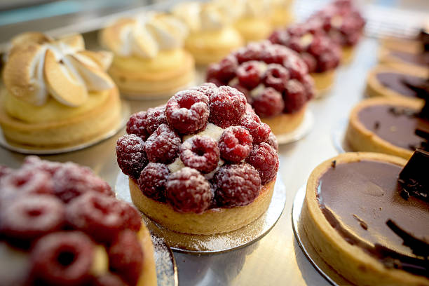 window of desserts at a pastry shop - food stock pictures, royalty-free photos & images