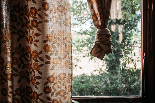 window with vintage flower cortains knotted - garden decoration stock-fotos und bilder