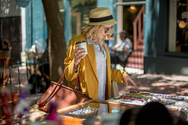 woman at outdoor market stall, cape town, south africa - fashion stock-fotos und bilder