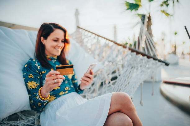 woman at summer vacation shopping online - travel stock pictures, royalty-free photos & images