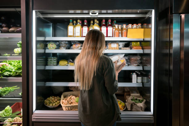 woman buying food at the supermarket - food stock pictures, royalty-free photos & images