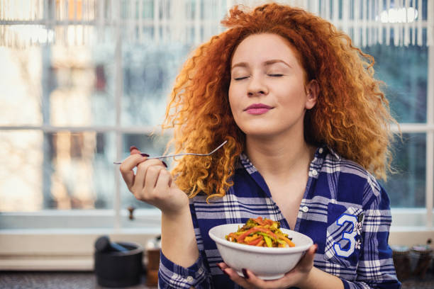 woman eating a healthy vegetarian meal - food stock pictures, royalty-free photos & images