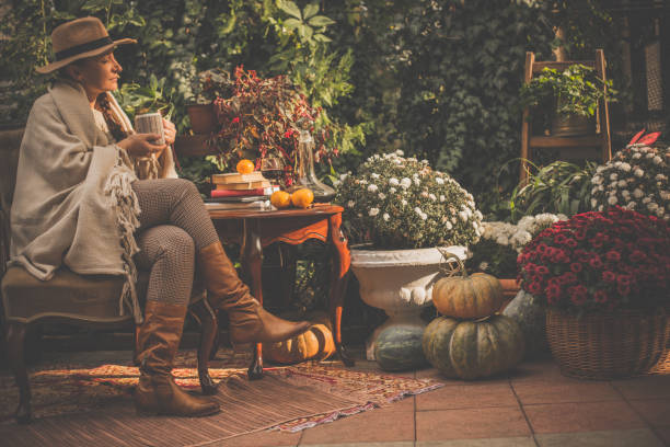 woman enjoying sunny day in back yard - garden decoration stock pictures, royalty-free photos & images