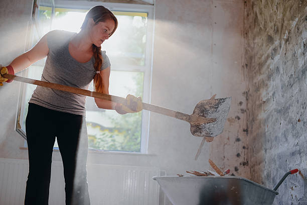 woman filling a wheelbarrow. - home decoration stock pictures, royalty-free photos & images