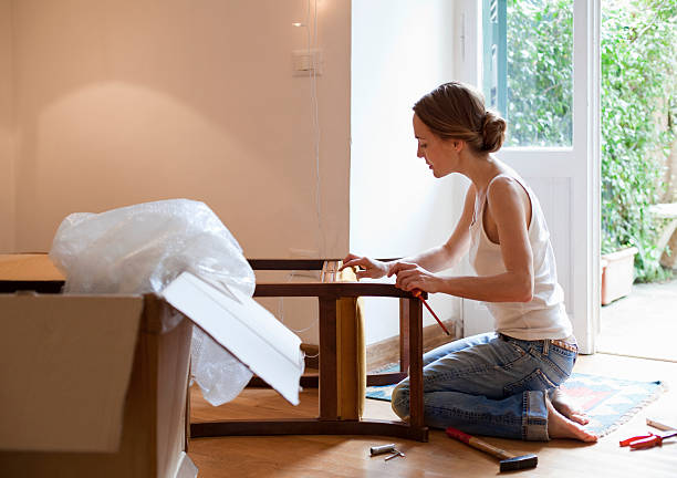 woman fixing piece of furniture - home decoration stock pictures, royalty-free photos & images