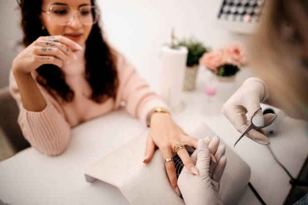 woman getting nails done - nails art stock pictures, royalty-free photos & images