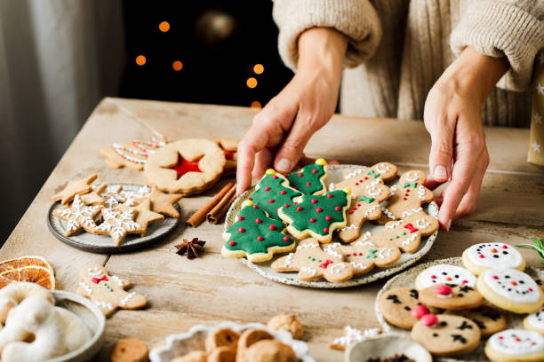 woman hands arranging sweets on christmas table - food stock pictures, royalty-free photos & images