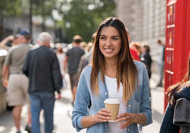 woman having coffee in the streets of london - junk food stock pictures, royalty-free photos & images