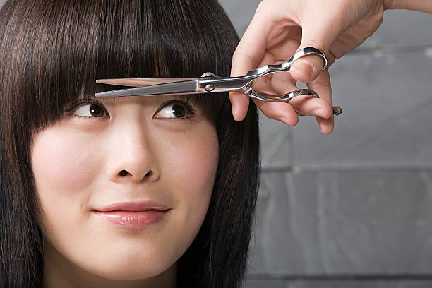 woman having her hair cut - hairstyle stockfoto's en -beelden
