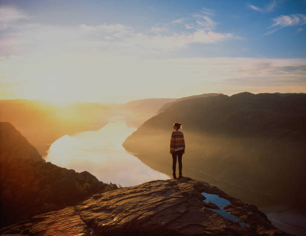 woman hiking in mountains on the background of lysefjorden - travel stock pictures, royalty-free photos & images