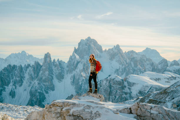 woman hiking in snow-covered dolomites in winter - travel stock pictures, royalty-free photos & images