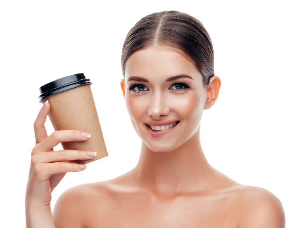 woman holds cup of coffee - junk food stock pictures, royalty-free photos & images