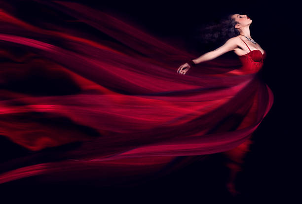 woman in a long red flowing dress - fashion stock pictures, royalty-free photos & images
