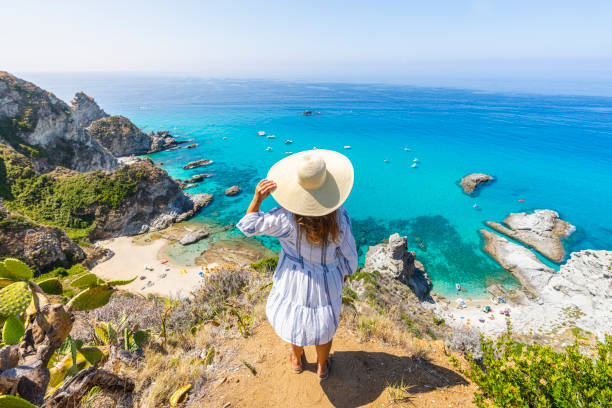 woman in capo vaticano, above the beaches of praia i focu, calabria, italy. - travel stock pictures, royalty-free photos & images