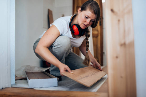 woman installing laminate flooring. - home decoration stock pictures, royalty-free photos & images