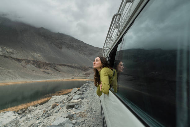 woman looking at mountains of northern pakistan from window in the van - travel stock pictures, royalty-free photos & images