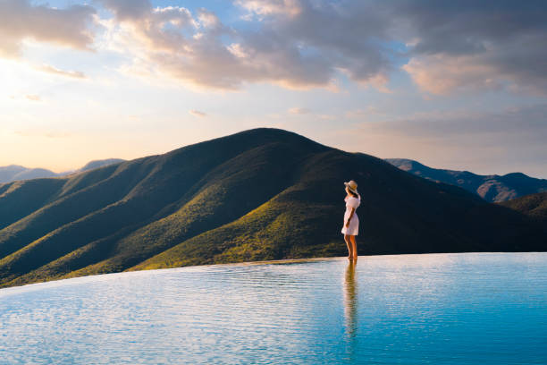 woman looking at view at hierve el agua, oaxaca, mexico - travel stock-fotos und bilder