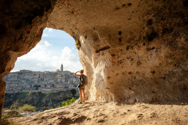 woman looking at view from a cave of matera, basilicata, italy - travel stock pictures, royalty-free photos & images