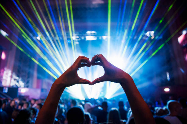 woman making heart shape with hands at music event - concert stock pictures, royalty-free photos & images