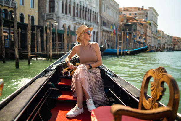 woman on a gondola tour sailing in grand canal in venice, italy - travel stock pictures, royalty-free photos & images