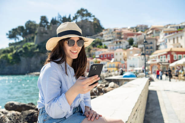 woman on a summer vacation using her phone. - travel stock pictures, royalty-free photos & images