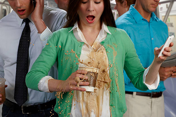woman on busy subway spilling coffee - coffee stock pictures, royalty-free photos & images