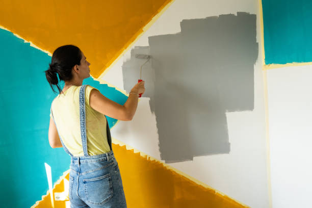 woman painting a wall at home - home decoration stock pictures, royalty-free photos & images