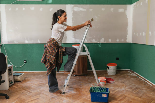 woman painting standing on a ladder - home decoration stock pictures, royalty-free photos & images