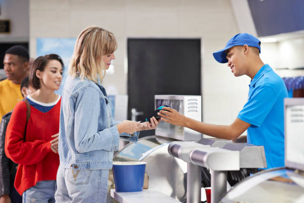 woman paying for snacks at concession stand - junk food stock pictures, royalty-free photos & images