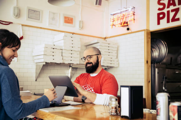 woman paying with credit card in pizzeria - junk food stock pictures, royalty-free photos & images