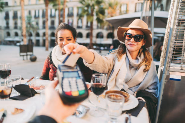 woman payng in restaurant - travel stock pictures, royalty-free photos & images