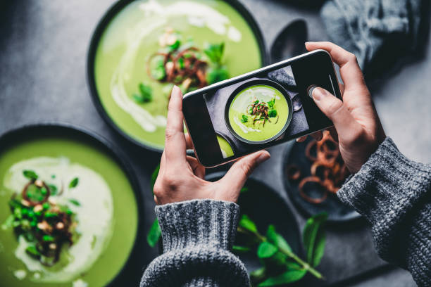woman photographing fresh green soup - food stock pictures, royalty-free photos & images