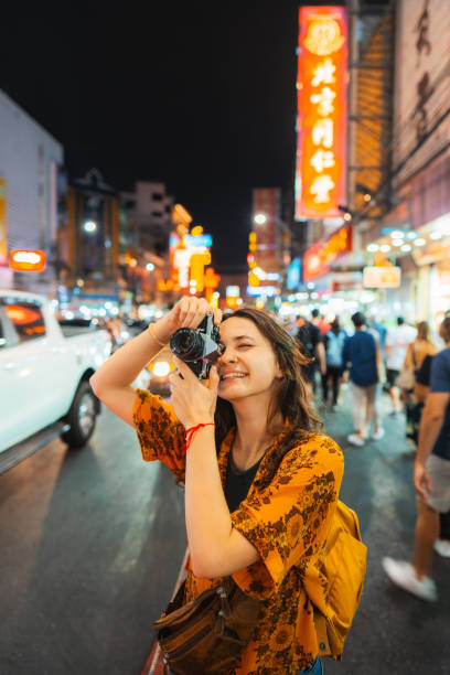 woman photographing with camera in chinatown, bangkok - travel stock pictures, royalty-free photos & images