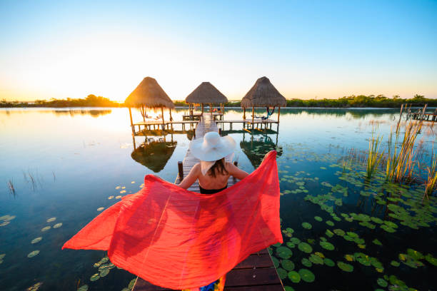 woman playing with red sarong on a pier, mexico - travel stock pictures, royalty-free photos & images