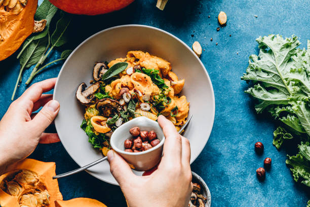 woman preparing autumn pumpkin meal - food stock pictures, royalty-free photos & images