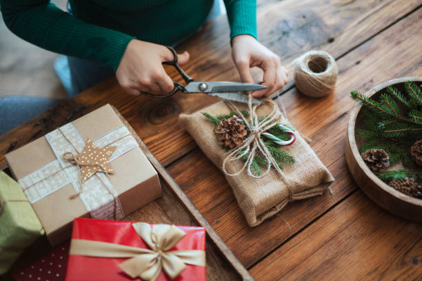 woman preparing christmas gift in rustic style with zero waste materieals. - home decoration stock pictures, royalty-free photos & images
