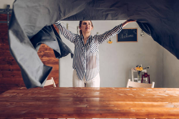 woman preparing dinner table - home decoration stock pictures, royalty-free photos & images