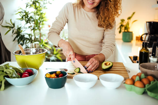 woman preparing salad - food stock pictures, royalty-free photos & images
