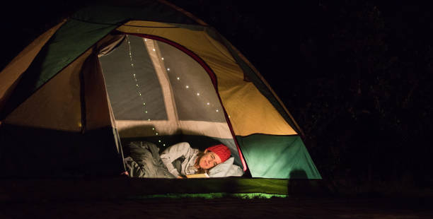 woman reading at night in tent - garden decoration stock pictures, royalty-free photos & images