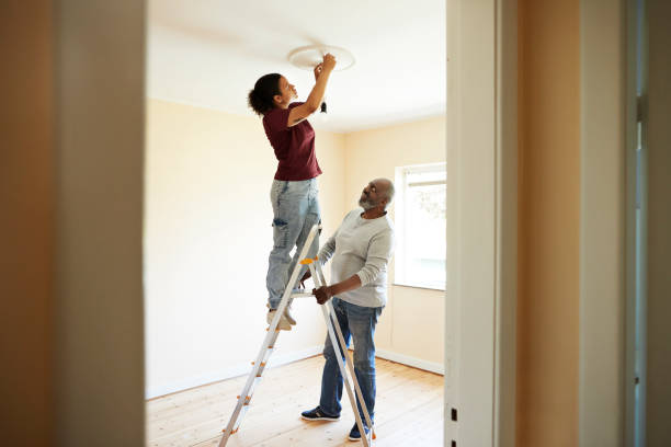 woman renovating home with father - home decoration stock pictures, royalty-free photos & images