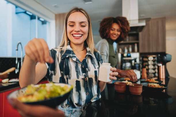 woman seasoning the salad - food stock pictures, royalty-free photos & images