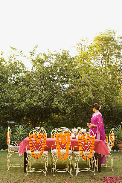 woman setting outdoor table - garden decoration stock pictures, royalty-free photos & images