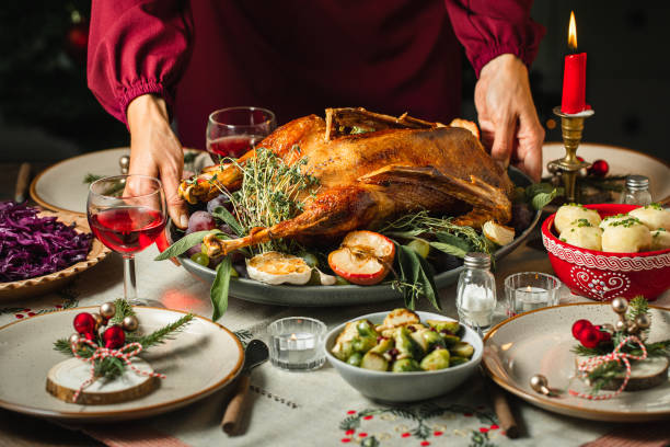 woman setting the table for christmas dinner - food stock pictures, royalty-free photos & images