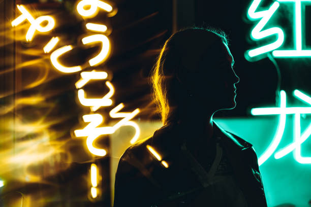 woman silhouette against neon signs at night - concert stock pictures, royalty-free photos & images