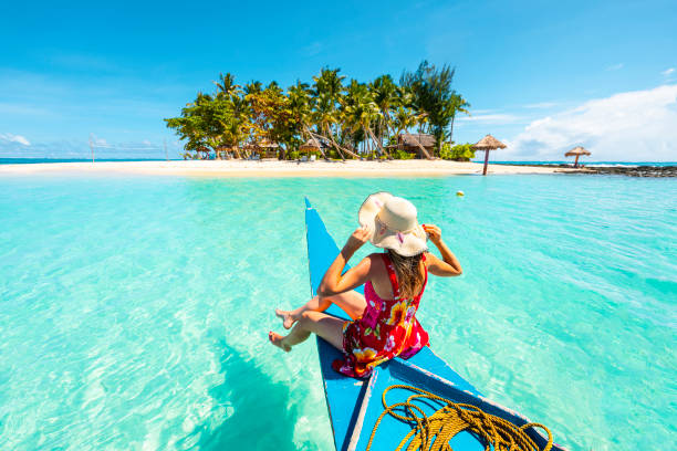woman sitting on bangka boat approaching a tropical island - travel stock pictures, royalty-free photos & images