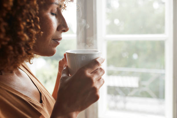woman smelling coffee - coffee stock pictures, royalty-free photos & images