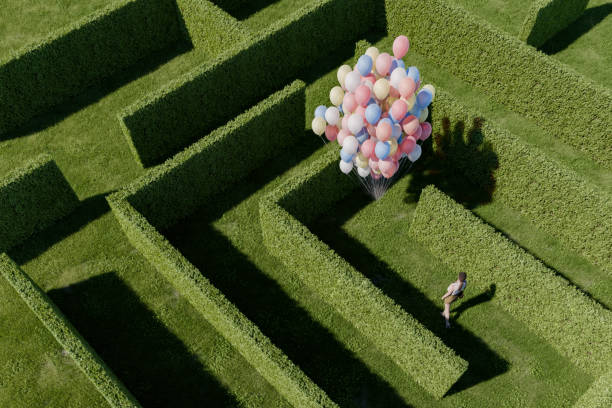 woman standing in hedge maze - garden decoration stock pictures, royalty-free photos & images